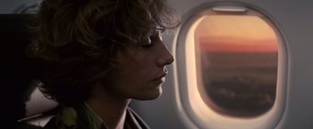 Movie still from “Hereafter” (2010), directed by Clint Eastwood – A woman looking out of a window on an airplane; Close Up shot, Low angle