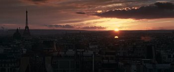 Movie still from “Hereafter” (2010), directed by Clint Eastwood – The sun is setting over a city skyline; Extreme Wide shot, Low angle