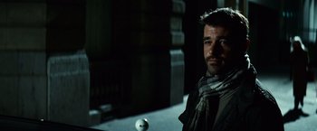 Movie still from “Hereafter” (2010), directed by Clint Eastwood – A man standing next to a ball in a dark room; Close Up shot, Over the shoulder angle