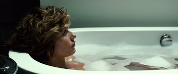 Movie still from “Hereafter” (2010), directed by Clint Eastwood – A woman sitting in a bath tub with water in it; Close Up shot, Over the shoulder angle