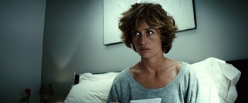 Movie still from “Hereafter” (2010), directed by Clint Eastwood – A woman sitting on a bed holding a piece of paper; Close Up shot, Over the shoulder angle