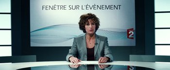 Movie still from “Hereafter” (2010), directed by Clint Eastwood – A woman sitting in front of a glass table; Medium shot, Over the shoulder angle