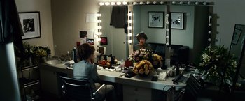 Movie still from “Hereafter” (2010), directed by Clint Eastwood – A woman sitting in front of a mirror in a dressing room; Wide shot, Over the shoulder angle