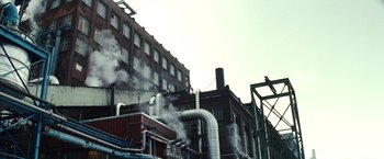 Movie still from “Hereafter” (2010), directed by Clint Eastwood – A building that has steam coming out of it; Extreme Wide shot, Low angle