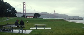Movie still from “Hereafter” (2010), directed by Clint Eastwood – A park bench in front of the golden gate bridge in san francisco; Extreme Wide shot, High angle