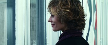 Movie still from “Hereafter” (2010), directed by Clint Eastwood – A person with curly brown hair; Close Up shot, Over the shoulder angle