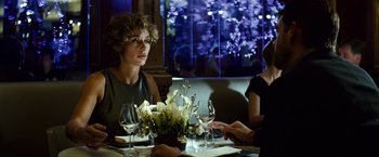 Movie still from “Hereafter” (2010), directed by Clint Eastwood – Two women sitting at a dinner table with wine glasses; Medium shot, Over the shoulder angle