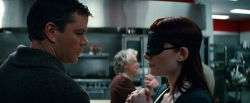Movie still from “Hereafter” (2010), directed by Clint Eastwood – A man and a woman wearing blindfolds in a kitchen; Close Up shot, Over the shoulder angle