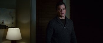 Movie still from “Hereafter” (2010), directed by Clint Eastwood – A man standing in front of a window wearing a sweater; Medium shot, Low angle