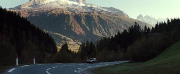Movie still from “Hereafter” (2010), directed by Clint Eastwood – A car driving down a road near a mountain; Extreme Wide shot, High angle