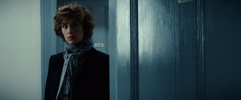 Movie still from “Hereafter” (2010), directed by Clint Eastwood – A woman standing in front of a blue door; Close Up shot, Over the shoulder angle