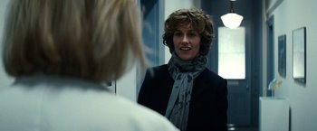 Movie still from “Hereafter” (2010), directed by Clint Eastwood – A woman in a black jacket is looking in the mirror; Close Up shot, Over the shoulder angle