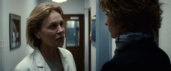 Movie still from “Hereafter” (2010), directed by Clint Eastwood – Two people standing next to each other in front of a door; Close Up shot, Over the shoulder angle