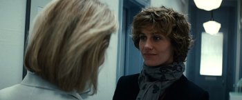 Movie still from “Hereafter” (2010), directed by Clint Eastwood – A woman is looking into the mirror while talking to another woman; Close Up shot, Over the shoulder angle