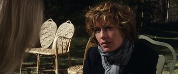 Movie still from “Hereafter” (2010), directed by Clint Eastwood – A person sitting on a chair; Close Up shot, Over the shoulder angle