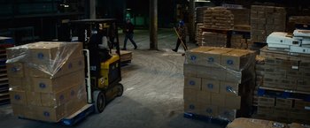 Movie still from “Hereafter” (2010), directed by Clint Eastwood – Two men in a warehouse with a forklift; Wide shot, High angle
