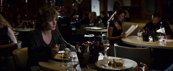 Movie still from “Hereafter” (2010), directed by Clint Eastwood – A group of people sitting at a table with wine glasses; Medium shot, Over the shoulder angle