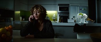 Movie still from “Hereafter” (2010), directed by Clint Eastwood – A woman sitting at a table talking on a phone; Medium shot, Low angle