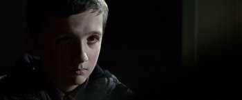 Movie still from “Hereafter” (2010), directed by Clint Eastwood – A young boy is crying in the dark; Close Up shot, Over the shoulder angle
