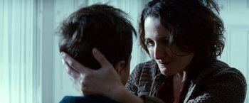 Movie still from “Hereafter” (2010), directed by Clint Eastwood – A woman and a boy are looking at each other; Close Up shot, Over the shoulder angle