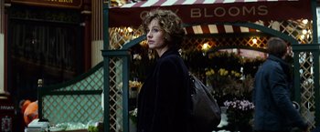 Movie still from “Hereafter” (2010), directed by Clint Eastwood – A woman standing in front of a flower shop; Medium shot, Over the shoulder angle
