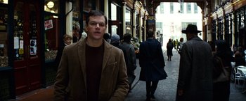 Movie still from “Hereafter” (2010), directed by Clint Eastwood – A man standing in the middle of an alley; Medium shot, Over the shoulder angle