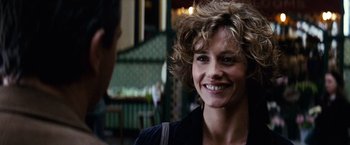 Movie still from “Hereafter” (2010), directed by Clint Eastwood – A person with curly hair smiling; Close Up shot, Over the shoulder angle