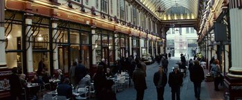 Movie still from “Hereafter” (2010), directed by Clint Eastwood – A group of people sitting at tables outside of a building; Extreme Wide shot, High angle