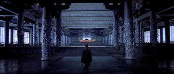 Movie still from “Hero” (2002), directed by Yimou Zhang – A man standing in front of an altar in a dark place; Extreme Wide shot, High angle