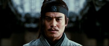 Movie still from “Hero” (2002), directed by Yimou Zhang – A person wearing a headband; Close Up shot, Low angle