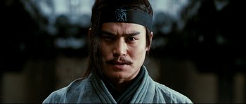 Movie still from “Hero” (2002), directed by Yimou Zhang – A person wearing a headband; Close Up shot, Low angle