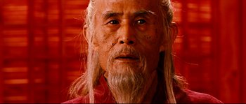 Movie still from “Hero” (2002), directed by Yimou Zhang – An old man with long hair and a beard; Close Up shot, Low angle