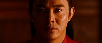 Movie still from “Hero” (2002), directed by Yimou Zhang – A man's face in a red shirt; Extreme Close Up shot, Low angle