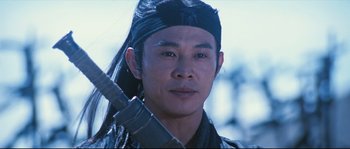 Movie still from “Hero” (2002), directed by Yimou Zhang – A person wearing a hat and holding a sword; Close Up shot, Low angle