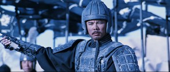 Movie still from “Hero” (2002), directed by Yimou Zhang – A man wearing a helmet and a suit of armor; Close Up shot, Low angle