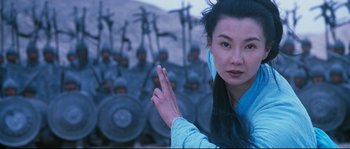Movie still from “Hero” (2002), directed by Yimou Zhang – A woman in a blue dress and a group of men in blue uniforms; Close Up shot, Low angle