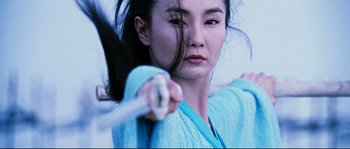 Movie still from “Hero” (2002), directed by Yimou Zhang – A woman is holding a baseball bat in her hands; Close Up shot, Low angle