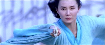 Movie still from “Hero” (2002), directed by Yimou Zhang – A woman in a blue dress is holding a gun; Medium shot, Low angle