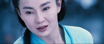 Movie still from “Hero” (2002), directed by Yimou Zhang – A woman's face in a blue shirt; Close Up shot, Over the shoulder angle