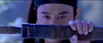 Movie still from “Hero” (2002), directed by Yimou Zhang – A man holding a knife up to his face; Close Up shot, Over the shoulder angle