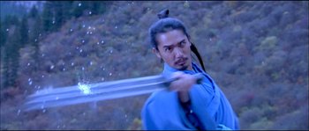Movie still from “Hero” (2002), directed by Yimou Zhang – A man holding a sword in his hand; Medium shot, Low angle