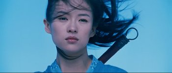 Movie still from “Hero” (2002), directed by Yimou Zhang – A young asian woman with long black hair; Close Up shot, Low angle