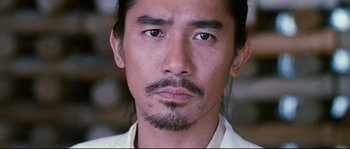 Movie still from “Hero” (2002), directed by Yimou Zhang – A person wearing a white shirt; Close Up shot, Low angle