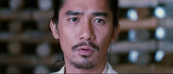 Movie still from “Hero” (2002), directed by Yimou Zhang – A person wearing a white shirt; Close Up shot, Low angle