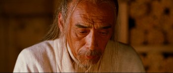 Movie still from “Hero” (2002), directed by Yimou Zhang – An older man with long hair and a beard; Close Up shot, High angle
