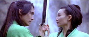 Movie still from “Hero” (2002), directed by Yimou Zhang – A man and a woman are holding a sword; Close Up shot, Low angle