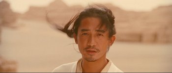 Movie still from “Hero” (2002), directed by Yimou Zhang – A person wearing a white shirt with long black hair; Close Up shot, Low angle