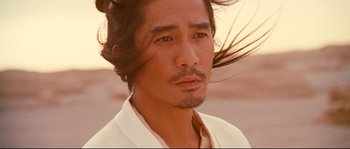 Movie still from “Hero” (2002), directed by Yimou Zhang – A person wearing a white shirt; Close Up shot, Low angle