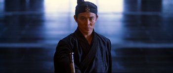 Movie still from “Hero” (2002), directed by Yimou Zhang – A man in a black robe holding a sword in his hand; Close Up shot, Low angle