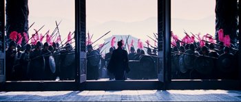 Movie still from “Hero” (2002), directed by Yimou Zhang – A group of people standing in front of a building; Extreme Wide shot, Low angle